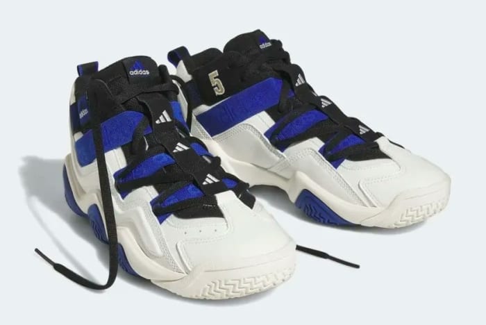 Side view of blue, black, and white adidas sneakers.